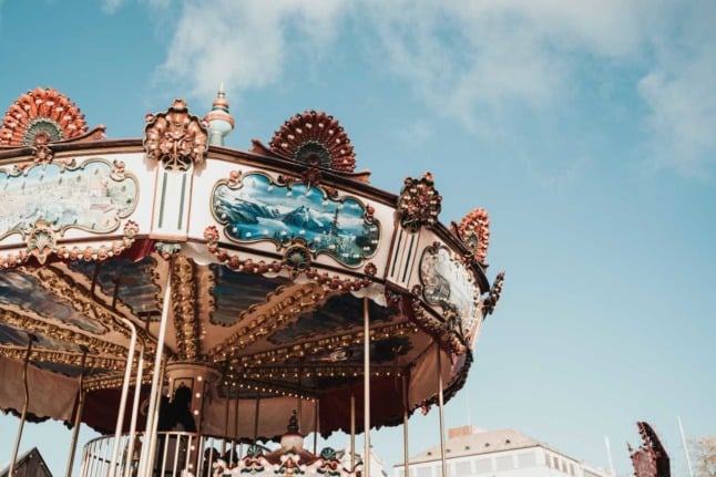 A carousel against a blue sky in the Swiss canton of Zurich. Photo by Chris Zueger on Unsplash