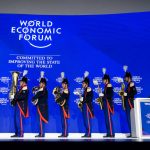Boos and brass band greet Trump in Davos