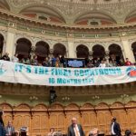 Singing climate activists disrupt Swiss parliament