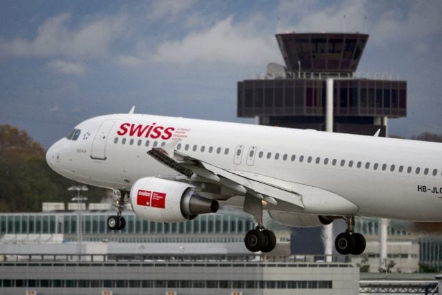 An Airbus A320 plane of Swiss International Air Lines is landing on November 12, 2012 in Geneva. The company owned by German airline Lufthansa said it would cut flights to Athens and Madrid, both hard-hit by the eurozone crisis, and would expand its flights to more lucrative destinations.  AFP PHOTO / FABRICE COFFRINI (Photo by Fabrice COFFRINI / AFP)