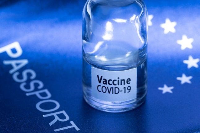 A picture taken on March 3, 2021 in Paris shows a vaccine vial reading 