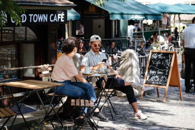 Cool people enjoying a cool coffee at a cool cafe in Geneva. Photo by Johan Mouchet on Unsplash