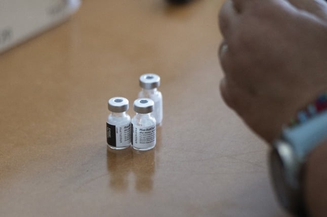 A healthworker prepares Pfizer vaccines.