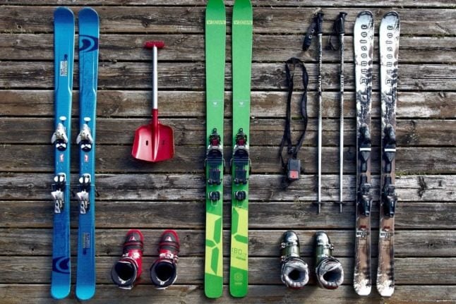 Skiing equipment laid out on wood